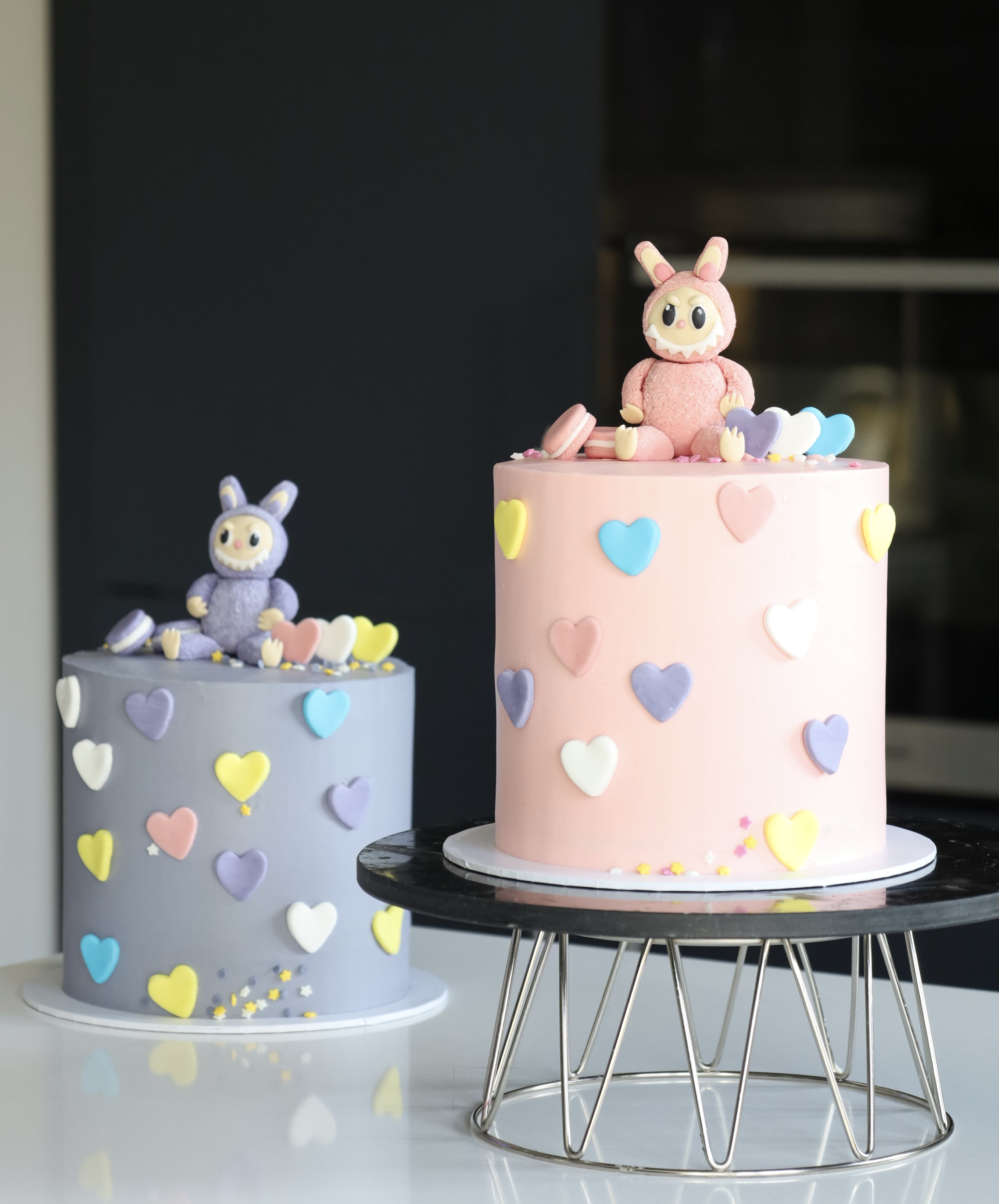 Pastel character celebration cakes with heart decorations