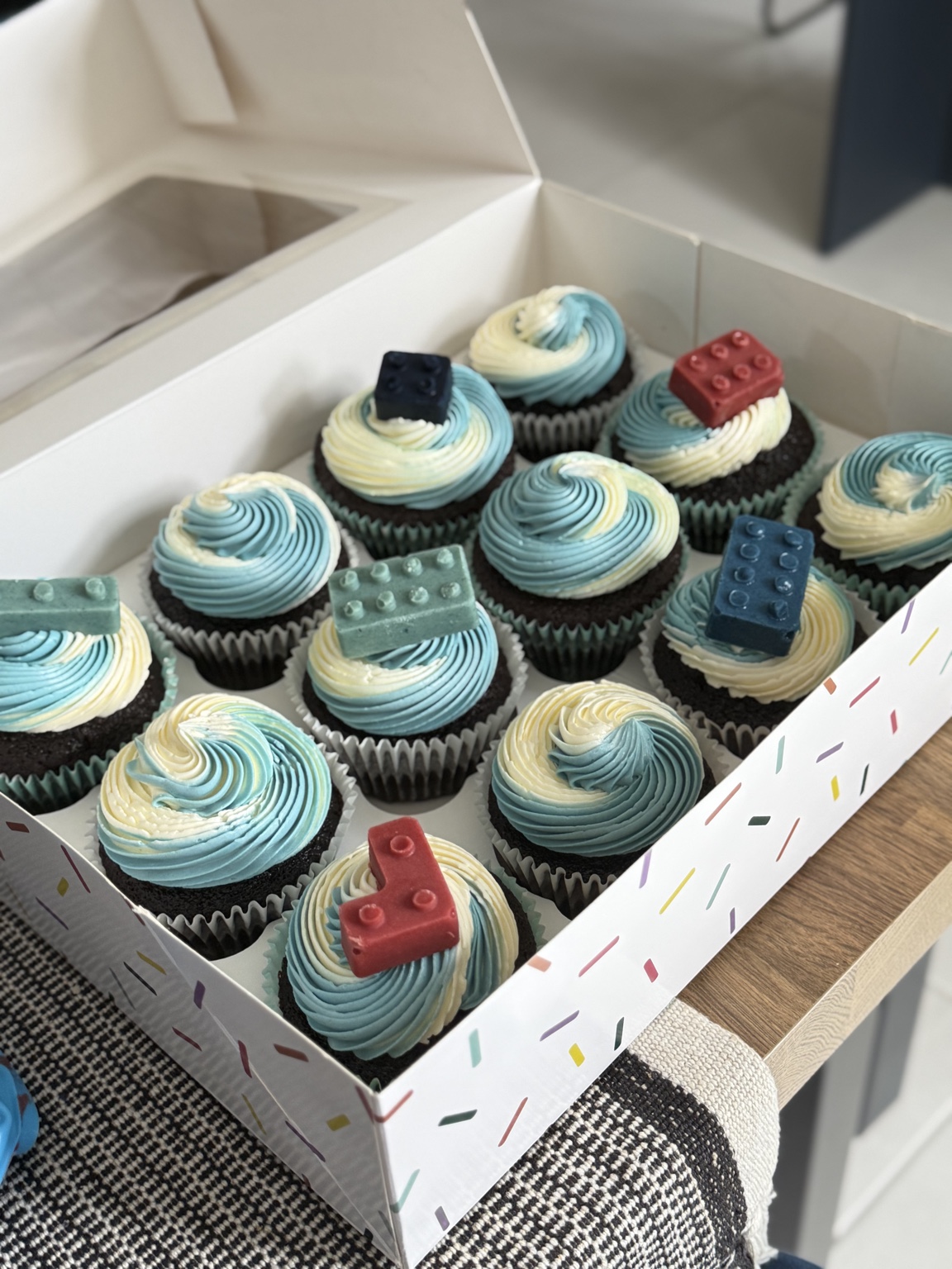 Blue cupcakes with building block decorations